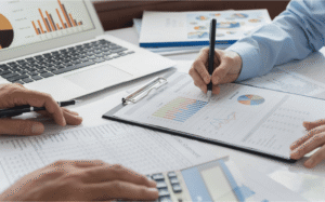 Organized financial statements, tax documents, and spreadsheets prepared for selling a business in Ontario, Canada
