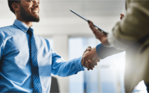 Handshake between buyer and seller during business sale negotiation and agreement process in London, Ontario, Canada